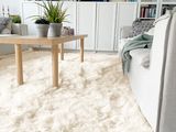 a white rug on the floor in a living room