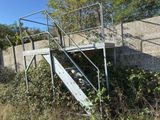 a metal stair going up to the top of a building
