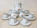 a lot of cups and saucers sitting on the floor