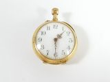 a gold pocket watch with a white face on a white surface