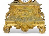 a gold clock that is sitting on top of a table