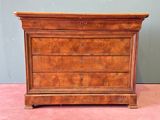 an antique chest of drawers on a pink carpeted floor
