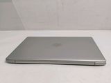 a silver laptop sitting on a table with a white background