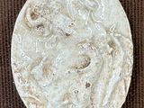 an image of a white circular object on a brown surface