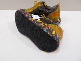 pair of black and yellow shoes with colorful floral design on them