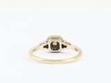 a yellow gold ring with a black and white diamond