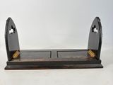 an image of a pair of black and gold bookends on a white background