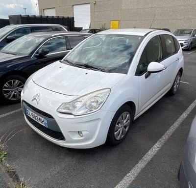a white car parked in a parking lot next to other cars
