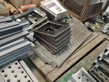 several pieces of metal are stacked on top of each other in a warehouse