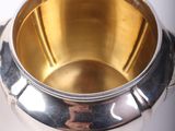 a silver cup that is sitting on a table