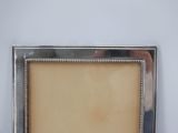 a picture of a silver picture frame on a table