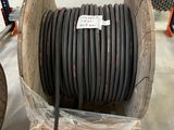 a large roll of black hose sitting on a pallet in a warehouse