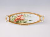 a gold tray with a painted lobster and palm leaves on it