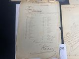 several old papers are on display on a table in a glass case