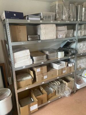 many boxes and boxes on the shelves in the room