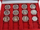 a red box with twelve silver coins in it