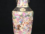 a vase that is sitting on a stand on a black background