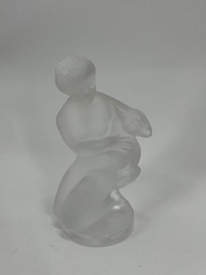 an image of a glass figurine of a boy on a skateboard