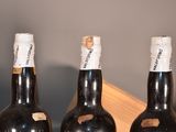 three bottles of wine that are sitting on a table