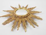 a gold sunburst on a white surface