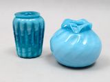 two blue vases sitting next to each other on a table