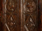a large wooden cabinet with carvings on the doors