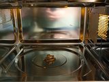 a close up of a microwave with food inside of it