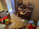 a view of a messy living room with a lot of clutter on the floor