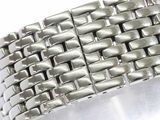 silver metal bracelet on a white surface on a white surface