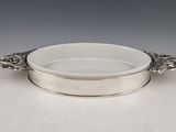 a silver plate with a handle and handles on a table