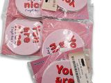 three pink buttons with the words you are nice on them