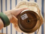 a person that is holding a cup with a tag on it