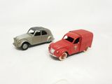 two toy cars sitting next to each other on a white surface