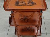 a wooden table with three trays on top of it