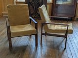 two chairs that are sitting in the middle of a room