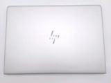 the back of a laptop computer sitting on top of a white table