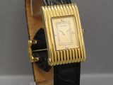 an image of a gold plated wrist watch with a black leather band