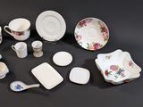 many different types of dishes and cups on the table