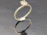 a gold ring with a pearl and a diamond on it
