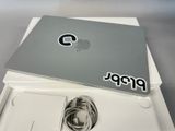 a laptop computer sitting on top of a white box