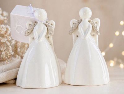 two white angel figurines sitting next to each other