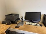 a desk with a computer and a printer on it