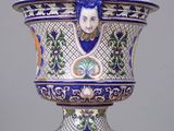 a large blue and white vase with a woman on it