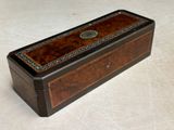 an old wooden box sitting on top of a white surface