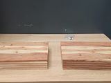 two pieces of wood sitting on top of a wooden table