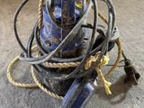 a pile of wires on the ground next to a blue object