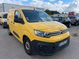 a yellow van parked in a parking lot next to other cars