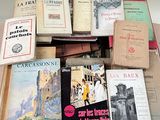 a lot of books that are stacked on top of each other
