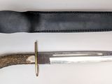 an image of a knife and sheath on a white surface