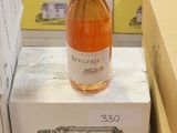 a bottle of wine sitting on top of a stack of boxes